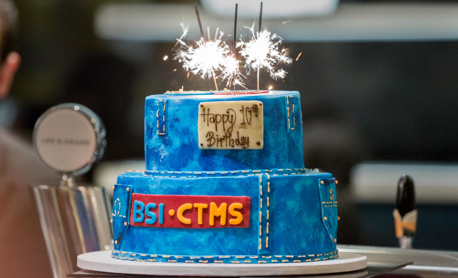 Picture of a blue birthday cake that says "BSI CTMS"