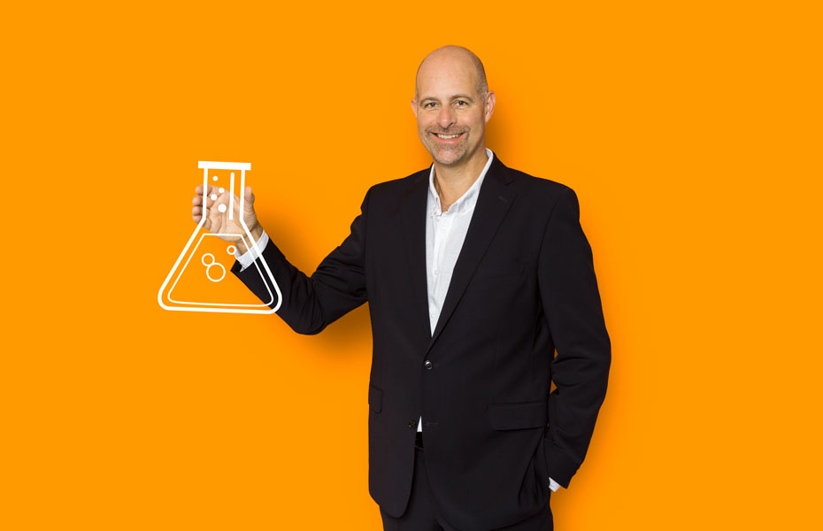 Photo of BSI Life Science's Jan Nielsen on an orange background and holding an illustrated lab flask 